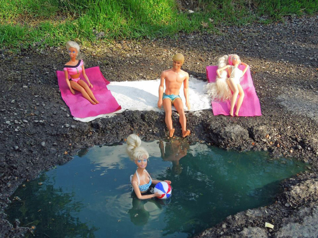 Barbie dolls decorate a pothole, from the guerrilla art campaign Pothole: Positively Filling Negative