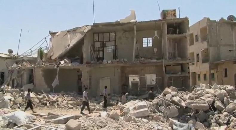Azaz, Syria: residents pick their way through bombed out buildings. Public Domain photo.
