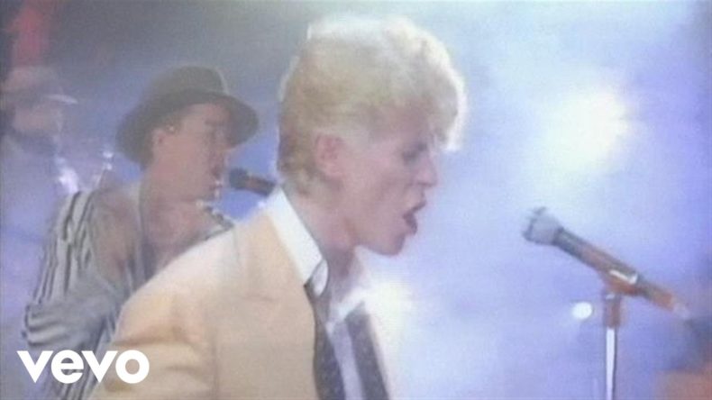 A Nigel Farage lookalike singing behind David Bowie - screenshot from Vevo