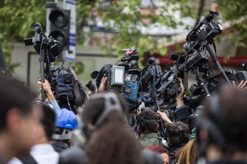 Media scrum with TV cameras