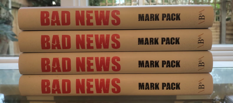 Copies of Bad News by Mark Pack on a shelf
