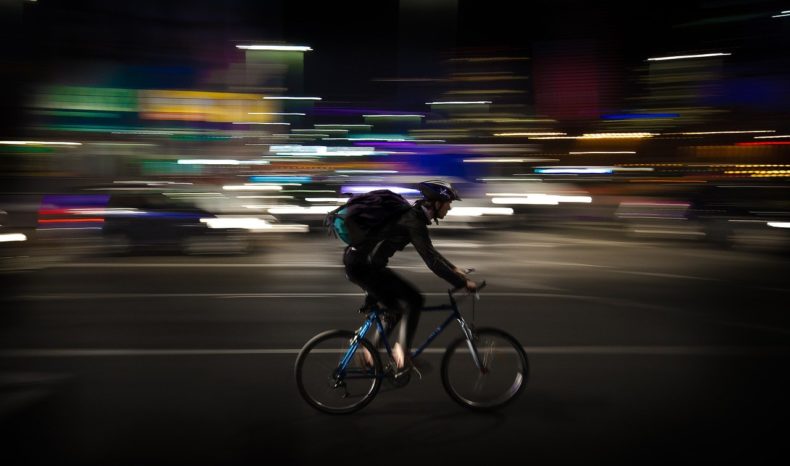 Courier cycling at night
