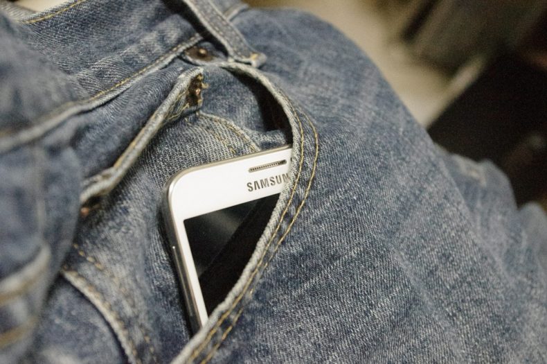 Smartphone in denim trousers pocket