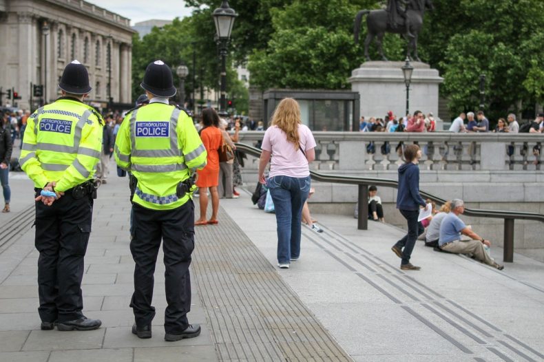 Two police officers in London with their backs to the camera