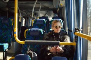 Woman on a bus with earphones