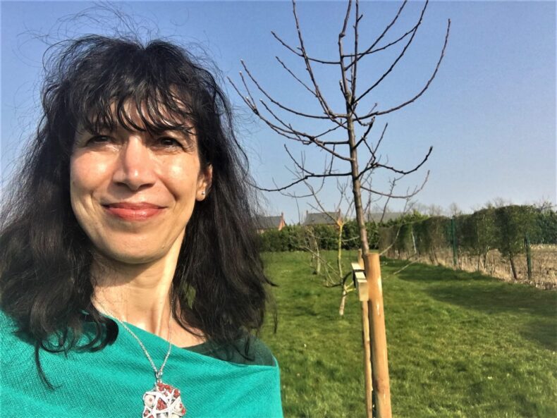 Manuela Perteghella standing by a tree