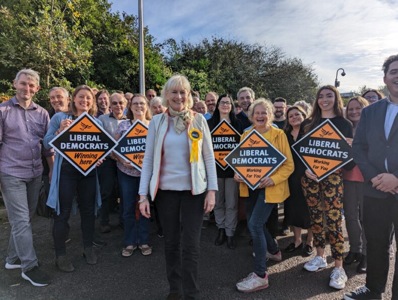 Penelope James and a group of Lib Dems holding posters